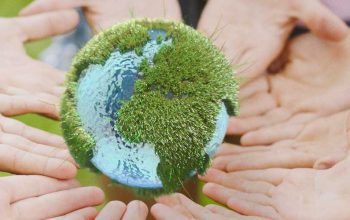people-holding-an-earth-miniature